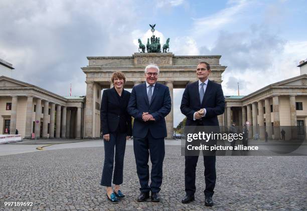 Michael Muller , Mayor of Berlin, as well as President Frank-Walter Steinmeier and his wife Elke Budenbender standing at the Pariser Platz in front...