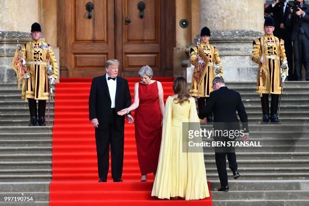 President Donald Trump, Britain's Prime Minister Theresa May, US First Lady Melania Trump and Philip May take their positions on the steps in the...