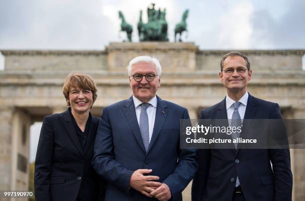 Dpatop - Berlin Mayor, Michael Muller , German Presidnent President Frank-Walter Steinmeier and his wife Elke Budenbender stand at the Pariser Platz...