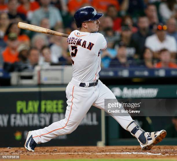 Alex Bregman of the Houston Astros doubles in two-runs in the third inning against the Oakland Athletics at Minute Maid Park on July 12, 2018 in...