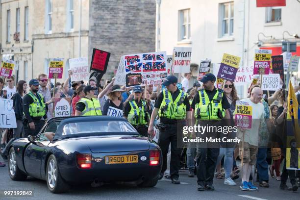 Protesters march to the gates of Blenheim Palace where US President Donald Trump is attending an evening function in Woodstock on July 12, 2018 in...