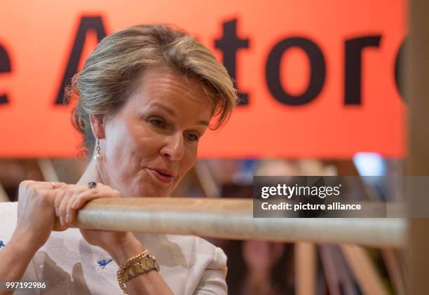 Queen Mathilde of Belgium visits the Frankfurt Book Fair in Frankfurt, Germany, 12 October 2017. She operates a replica of a historical book press in...