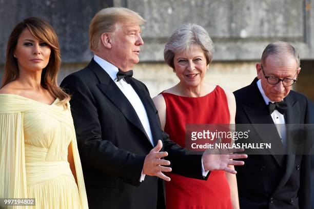 First Lady Melania Trump, US President Donald Trump, Britain's Prime Minister Theresa May, and her husband Philip May stand on the steps in the Great...
