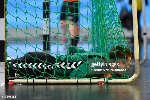 Zagreb's goalkeeper Matevz Skok lies injured in the goal during the handball Champions League group stage match between Rhein-Neckar Loewen and RK...