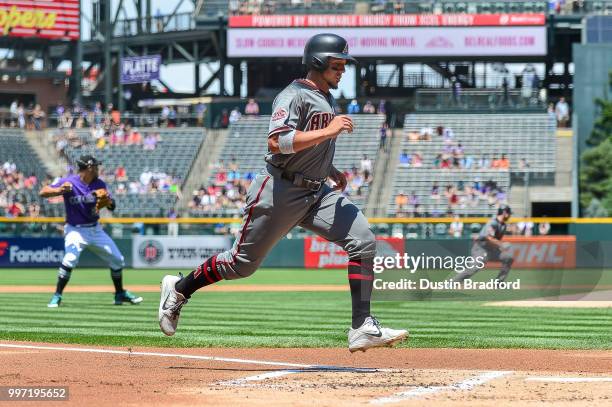 Jon Jay of the Arizona Diamondbacks scores a first inning run on a single by A.J. Pollock during a game against the Colorado Rockies at Coors Field...