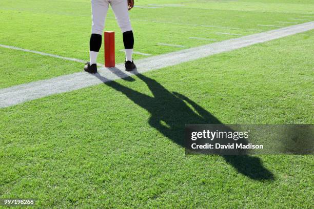 american football referee standing near goal line marker - goal line stock pictures, royalty-free photos & images