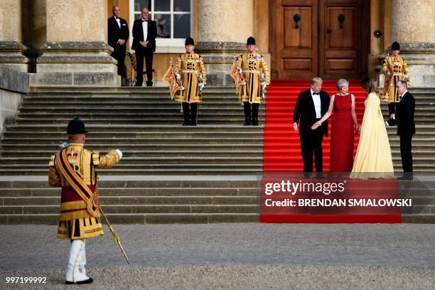 President Donald Trump, Britain's Prime Minister Theresa May, US First Lady Melania Trump and Philip May take their position on the steps in the...