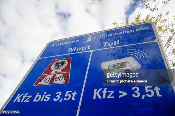 Road sign informs about the toll on Austrian streets at the border between Germany and Austria on the highway 93 in Niederndorf near Kufstein,...