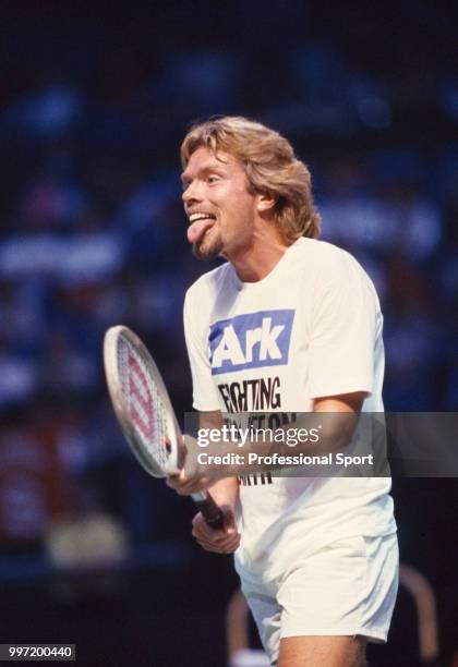 British entrepreneur and philanthropist Richard Branson in action during a charity tennis match, circa 1989.