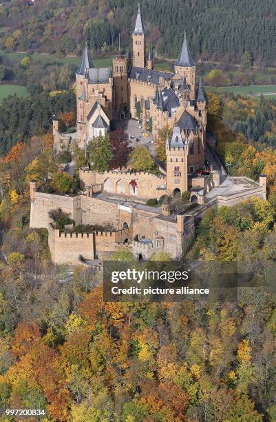 The Hohenzollern Castle is surrounded by autumnally coloured trees near Bisingen, Germany, 13 October 2017. Photo: Thomas Warnack/dpa