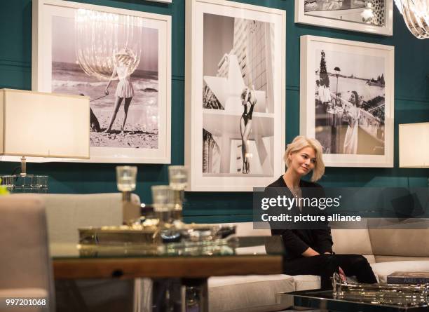 Model Louisa sits in the set-up of a New York Suit during a pre-tour of the event and sales trade show 'infa' in Hanover, Germany, 13 October 2017....