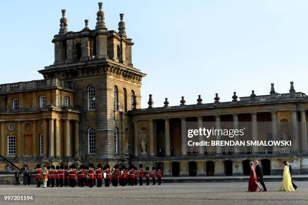 Britain's Prime Minister Theresa May and her husband Philip May walk with US President Donald Trump and US First Lady Melania Trump as they arrive...