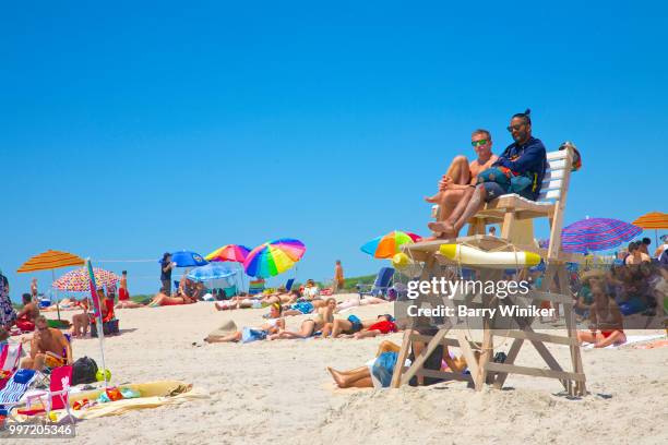 lifeguards surrounded by people on sand at jones beach, ny - wantagh stock pictures, royalty-free photos & images