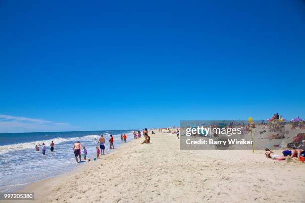 people relaxing near and in water at jones beach, ny - wantagh fotografías e imágenes de stock