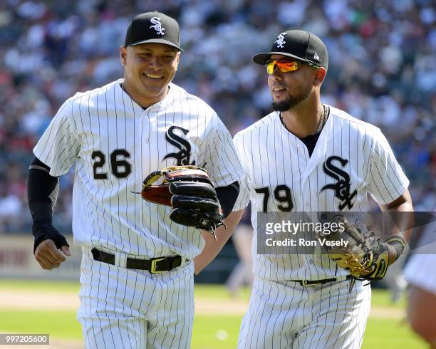 Avisail Garcia of the Chicago White Sox smiles after making a diving catch of a baseball hit by Brian Dozier of the Minnesota Twins as Jose Abreu...