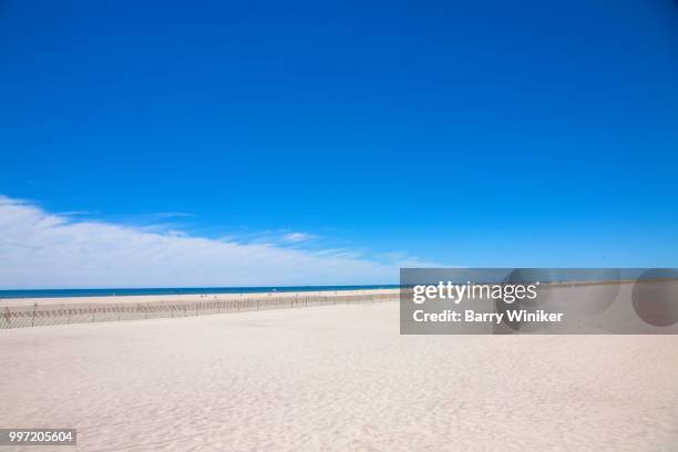 white sand beach under vibrant blue sky, jones beach, ny - wantagh stock pictures, royalty-free photos & images