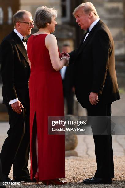 Britain's Prime Minister Theresa May and her husband Philip May greet U.S. President Donald Trump at Blenheim Palace on July 12, 2018 in Woodstock,...