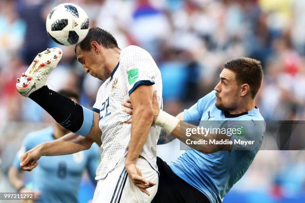Sebastian Coates of Uruguay tackles Artem Dzyuba of Russia during the 2018 FIFA World Cup Russia group A match between Uruguay and Russia at Samara...