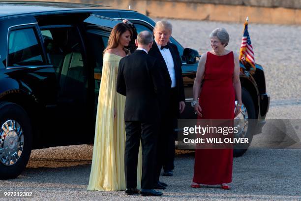 President Donald Trump and US First Lady Melania Trump are welcomed by Britain's Prime Minister Theresa May and her husband Philip May as they arrive...