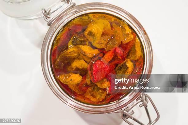 dried tomatoes in glass jar - arina stock pictures, royalty-free photos & images