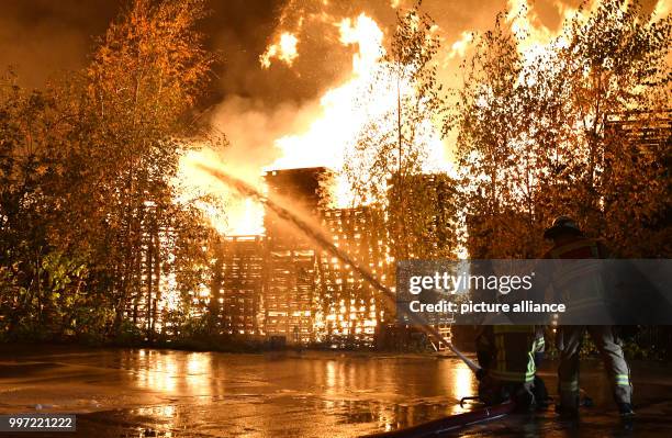 Firefighters try to control a fire in Alt-Hohenschoenhausen, a part of Berlin, Germany, 13 October 2017. About 80 firefighters are involved. Photo:...