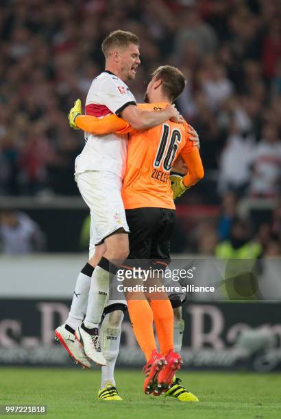 Stuttgart's Simon Terodde and teammate and goalkeeper Ron-Robert Zieler celebrate after the winning 2-1 goal during the Bundesliga soccer match VfB...