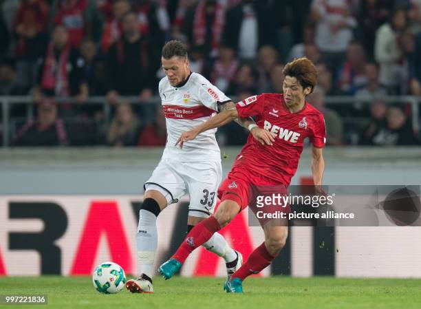 Cologne's Yuya Osako and Stuttgart's Daniel Ginczek in action during the Bundesliga soccer match VfB Stuttgart vs 1st FC Cologne in Stuttgart,...