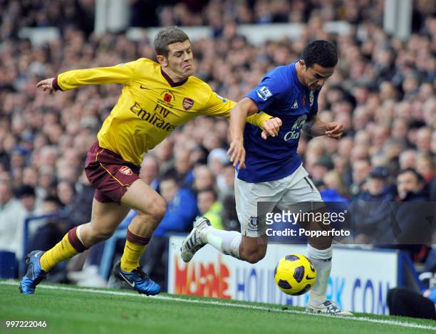 Tim Cahill of Everton and Jack Wilshere of Arsenal battle for the ball during a Barclays Premier League match at Goodison Park on November 14, 2010...