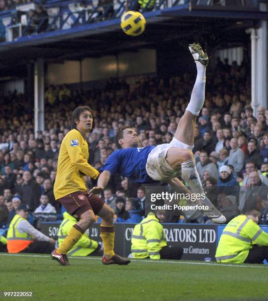 Phil Jagielka of Everton makes an athletic clearance away from Tomas Rosicky of Arsenal during a Barclays Premier League match at Goodison Park on...