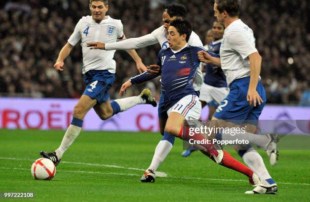 Samir Nasri of France gets away from Steven Gerrard , Joleon Lescott and Phil Jagielka of England during an International Friendly at Wembley Stadium...