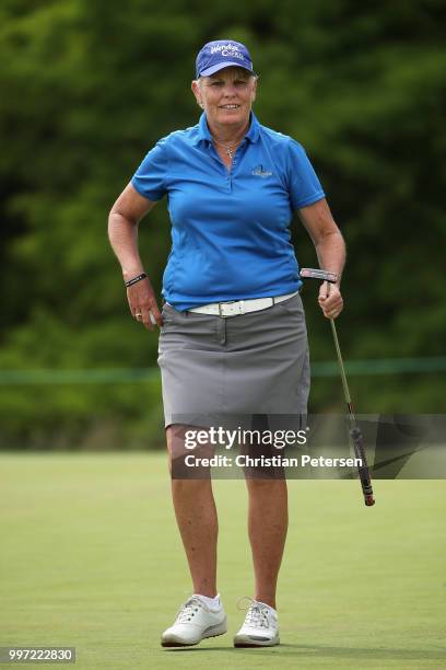 Elaine Crosby reacts to her putt on the 18th green during the first round of the U.S. Senior Women's Open at Chicago Golf Club on July 12, 2018 in...