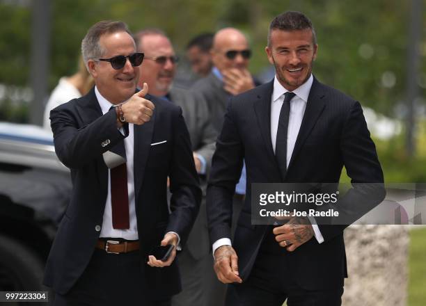 Jorge Mas and David Beckham arrive for a rally being held next to Miami City Hall in support of building a Major League Soccer stadium on July 12,...