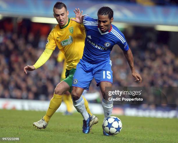 Florent Malouda of Chelsea holds off Lubomir Guldan of MSK Zilina during a Champions League Group F match at Stamford Bridge on November 23, 2010 in...