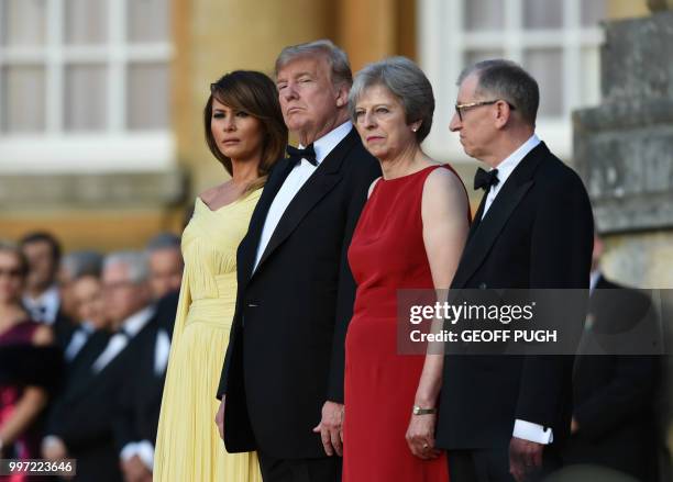 First Lady Melania Trump, US President Donald Trump, Britain's Prime Minister Theresa May and her husband Philip May stand on steps in the Great...