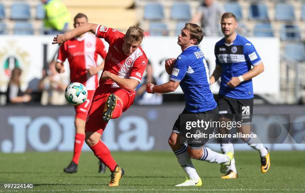 Bielefeld's Tom Schuetz and Duesseldorf's Rouwen Hennings vie for the ball during the German 2nd division Bundesliga soccer match between Arminia...