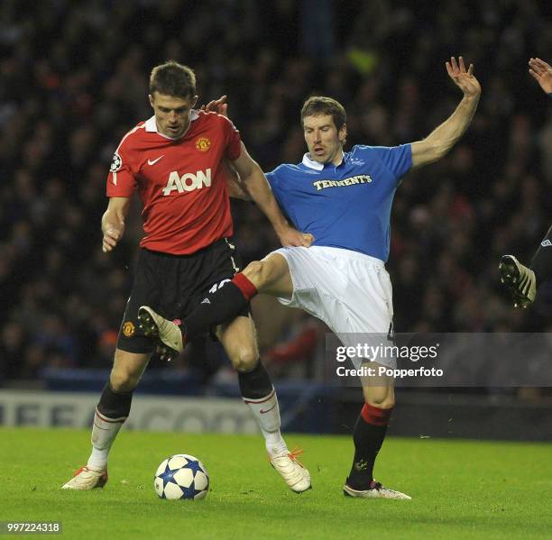 Michael Carrick of Manchester United is challenged by Kirk Broadfoot of Glasgow Rangers during a UEFA Champions League Group C match at Ibrox Park on...