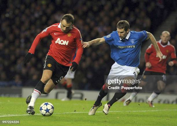 Dimitar Berbatov of Manchester United is closed down by Kirk Broadfoot of Glasgow Rangers during a UEFA Champions League Group C match at Ibrox Park...