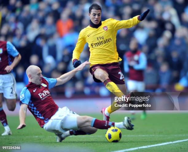 Marouane Chamakh of Arsenal is tackled by James Collins of Aston Villa during a Barclays Premier League match at Villa Park on November 27, 2010 in...