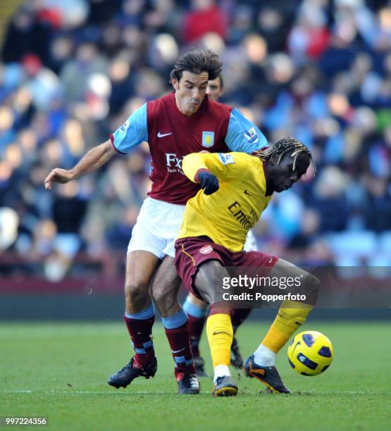 Robert Pires of Aston Villa puts Bacary Sagna of Arsenal under pressure during a Barclays Premier League match at Villa Park on November 27, 2010 in...