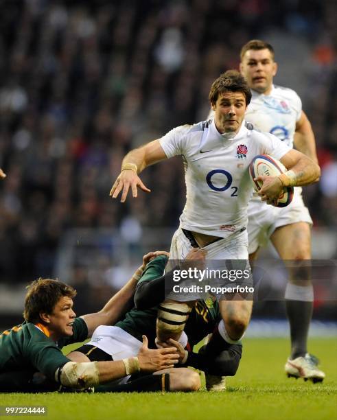 Ben Foden of England is tackled by Juan Smith and Ruan Pienaar of South Africa during the Investec International match between England and South...