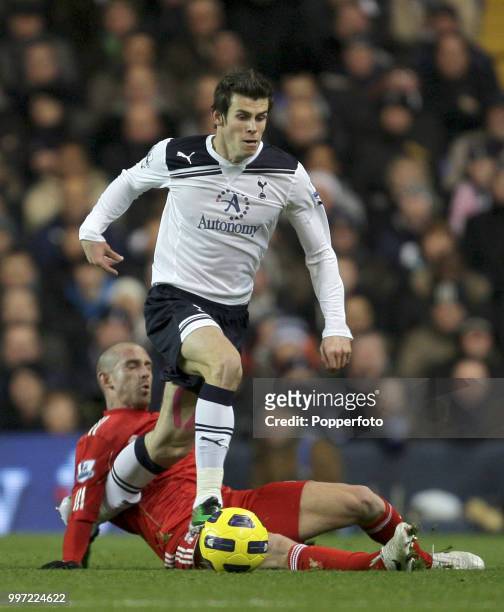 Gareth Bale of Tottenham Hotspur gets away from the challenge of Raul Meireles of Liverpool during a Barclays Premier League match at White Hart Lane...