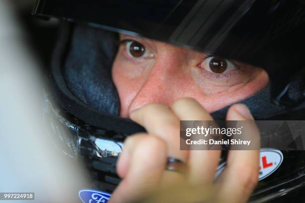 Paul Menard, driver of the Discount Tire Ford, sits in his car during practice for the NASCAR Xfinity Series Alsco 300 at Kentucky Speedway on July...