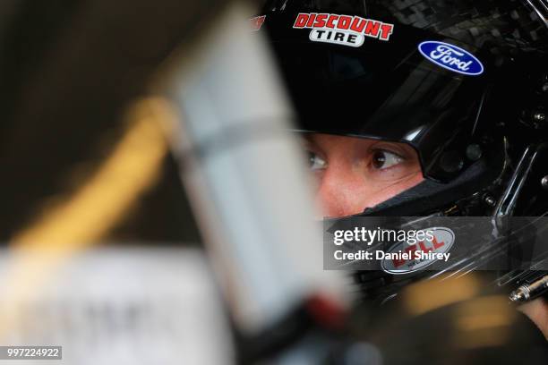 Paul Menard, driver of the Discount Tire Ford, sits in his car during practice for the NASCAR Xfinity Series Alsco 300 at Kentucky Speedway on July...