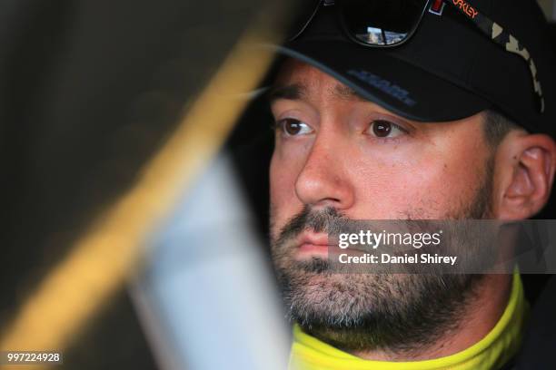 Paul Menard, driver of the Discount Tire Ford, sits in his car during practice for the NASCAR Xfinity Series Alsco 300 at Kentucky Speedway on July...