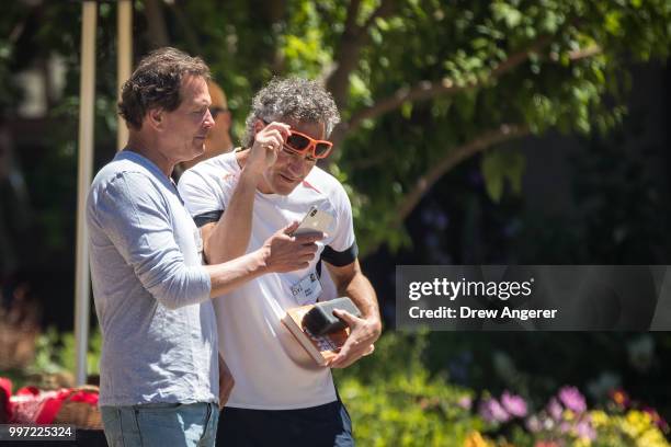 Dan Schulman, president and chief executive officer of PayPal Inc., and Alex Karp, chief executive officer of Palantir Technologies, talk with each...