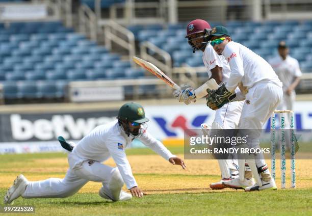 Kraigg Brathwaite of West Indies hits past Liton Das and Nurul Hasan of Bangladesh during Day 1 of the 2nd Test between West Indies and Bangladesh at...