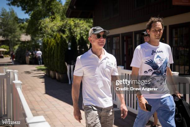 Jeff Bezos, chief executive officer of Amazon, and John Elkann, chairman of Fiat Chrysler Automobiles, walk together during the annual Allen &...