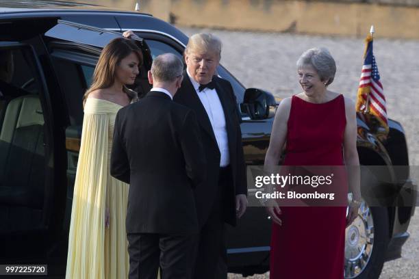 President Donald Trump, center, speaks while Theresa May, U.K. Prime minister, from right, U.S. First lady Melania Trump, and Philip May, husband of...