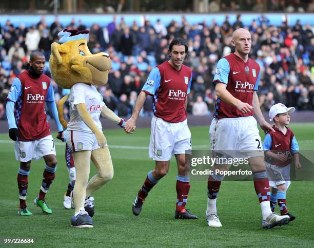 Ashley Young , Robert Pires and James Collins of Aston Villa walk out with mascots before the Barclays Premier League match between Aston Villa and...