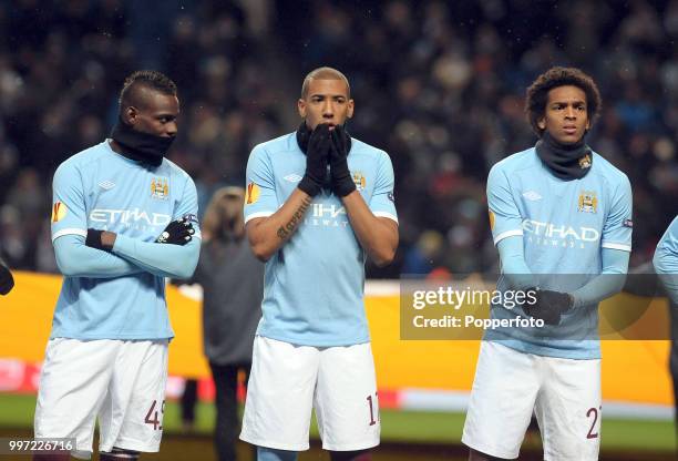 Mario Balotelli , Jerome Boateng , and Silva of Manchester City line up before the UEFA Europa League Group A match between Manchester City and Red...